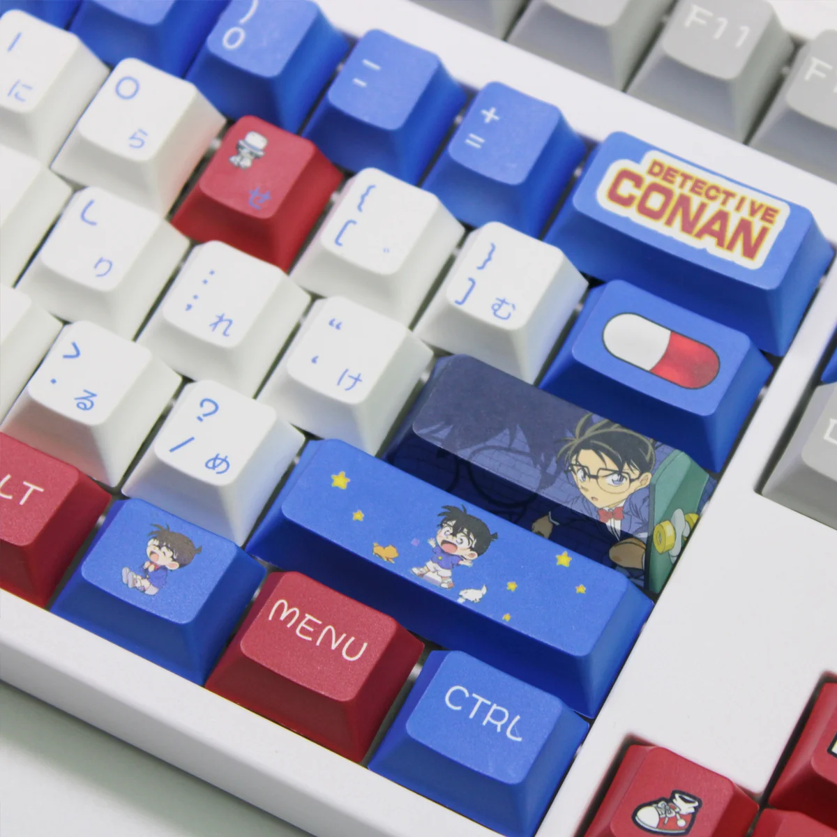 A playful gallery of iconic Detective Conan PBT keycaps set, showcasing vibrant anime characters and symbols from multiple angles and diverse profiles.