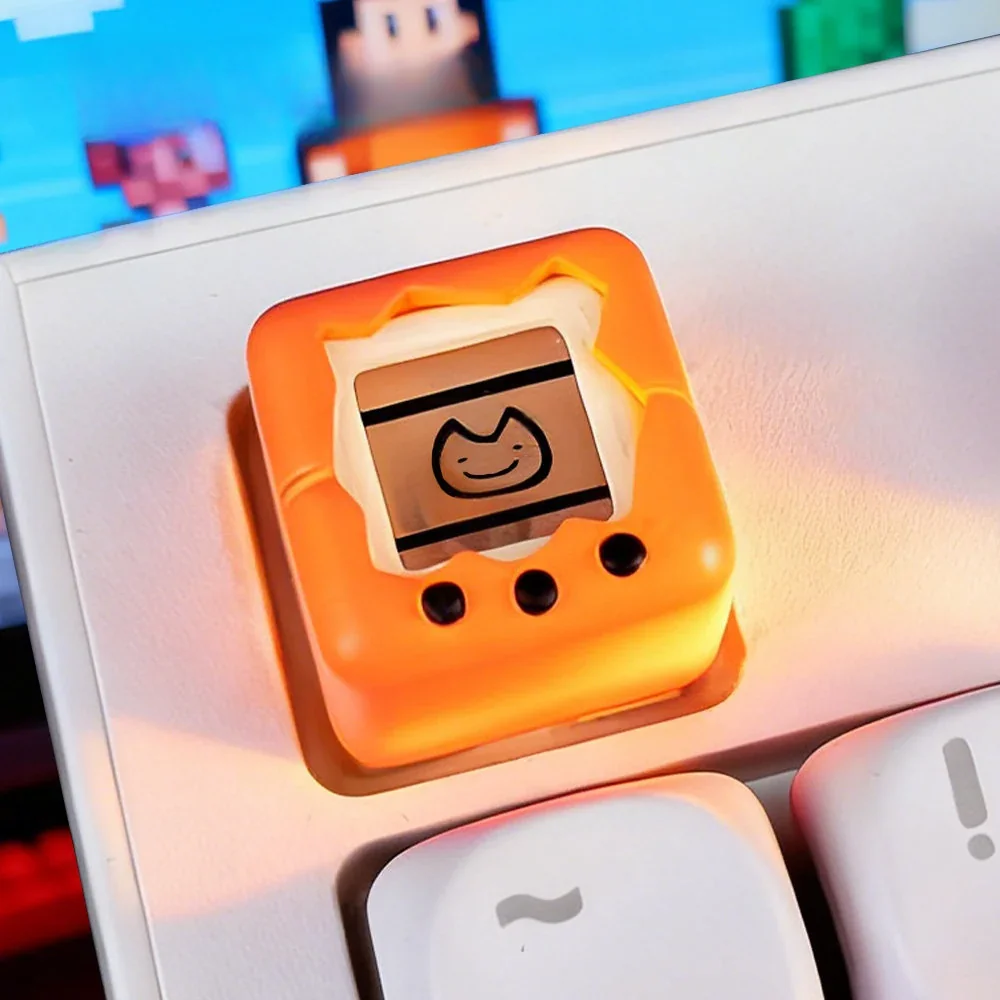 This nostalgic electronic pet keycap features a detailed retro game console design, playfully displayed from various angles.