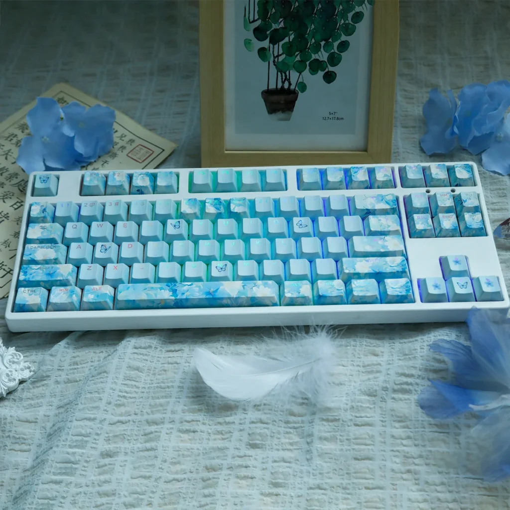 Endless Summer PBT dye-sublimated keycaps set in soft pastel blues, greens, and whites, offering a durable and serene artistic keyboard aesthetic.