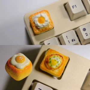 Whimsical handcrafted 3D fried egg toast artisan keycap, displaying a vibrant yellow yolk and white on miniature toast, a truly unique fried egg keycap.