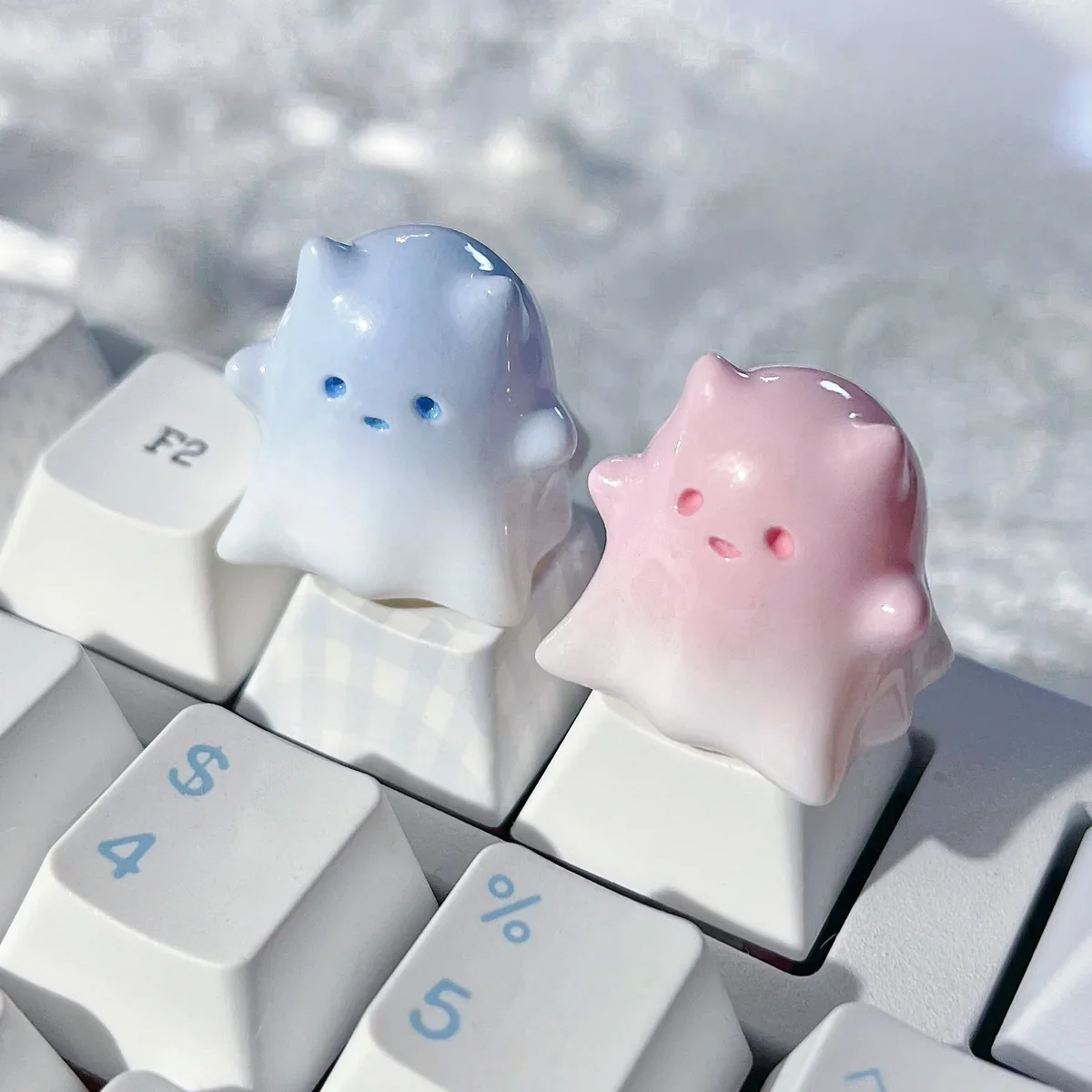 Artistic gallery showcasing the whimsical Ghost Cat Keycap's hand-painted resin, translucent pastel hues, and unique ethereal design from multiple angles.