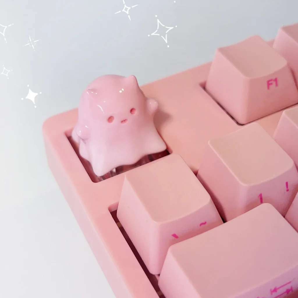 Close-up views of the whimsical ghost cat keycap, showcasing its hand-painted resin details, translucent pastel gradients, and unique ethereal design.