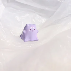 Hand-painted resin Whimsical Ghost Cat Keycap featuring a unique taro-purple head and translucent body, an ethereal piece of art.