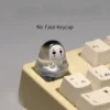Cute handmade glowing No-Face keycap, a whimsical translucent 3D artisan figure casting an ethereal glow on a mechanical keyboard.
