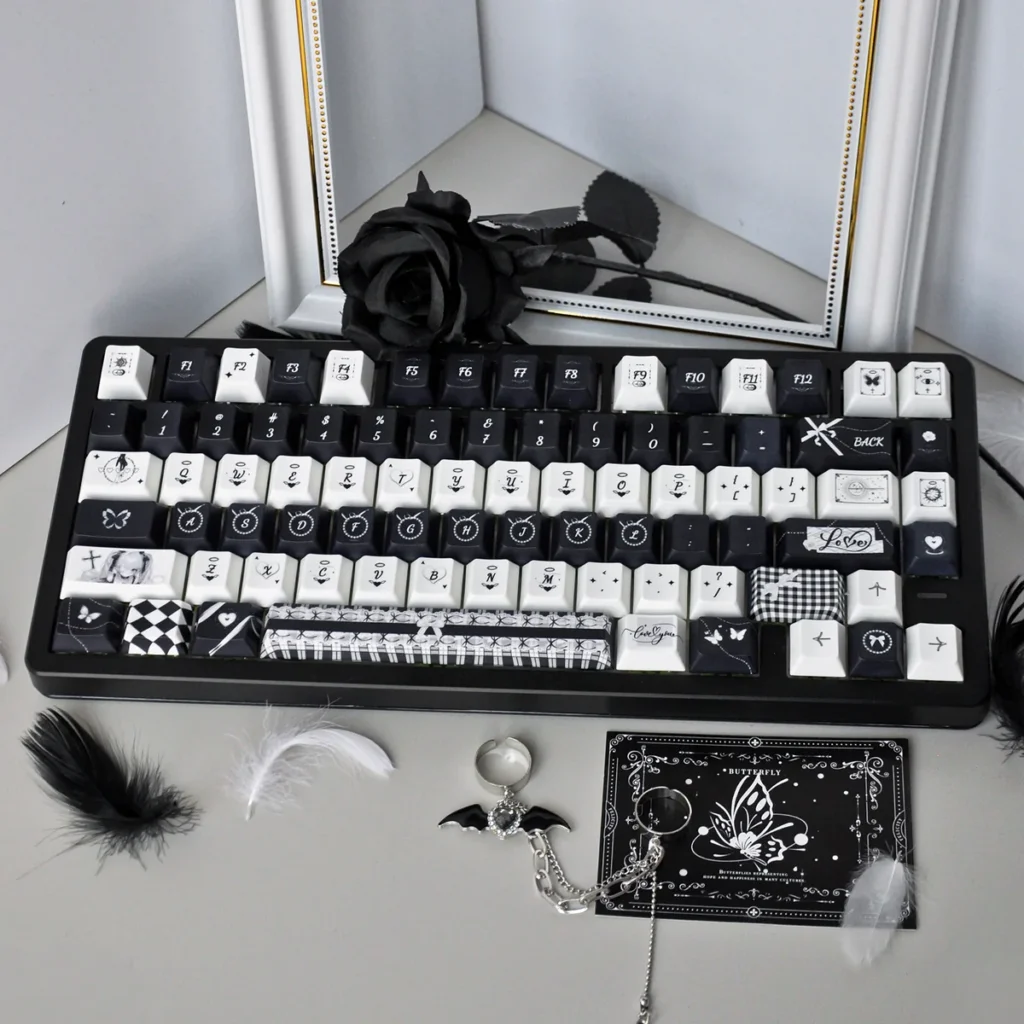 Gothic Lace PBT Keycap Set displaying intricate black lace patterns on white keys, showcasing its unique gothic design for a dreamlike, artistic keyboard.