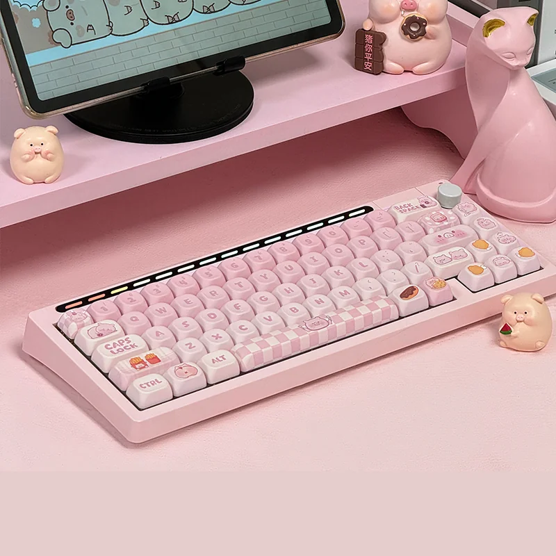 A playful arrangement of the Adorable Greedy Pig PBT keycap set, featuring vibrant, food-inspired dye-sub cartoon characters.