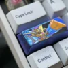 Gundam Titanium Keycap, 2.25U, showcasing its premium anodized titanium alloy from various angles. The intricate mecha spirit design reflects iconic design.