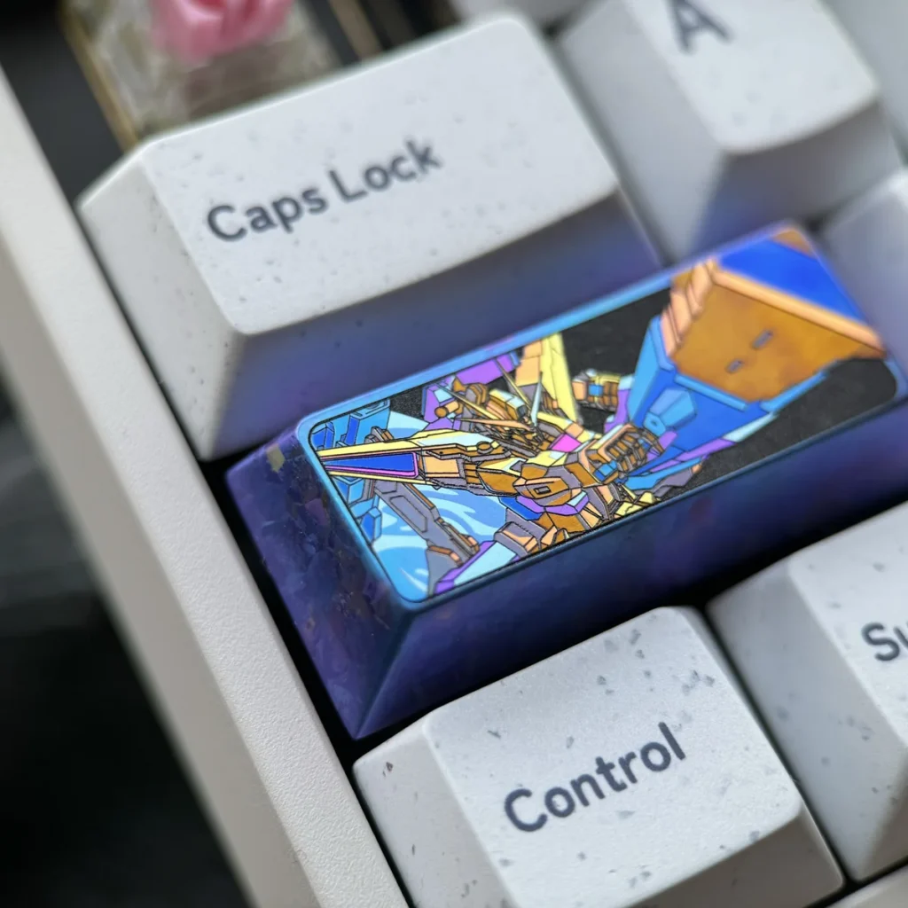 Gundam Titanium Keycap, 2.25U, showcasing its premium anodized titanium alloy from various angles. The intricate mecha spirit design reflects iconic design.