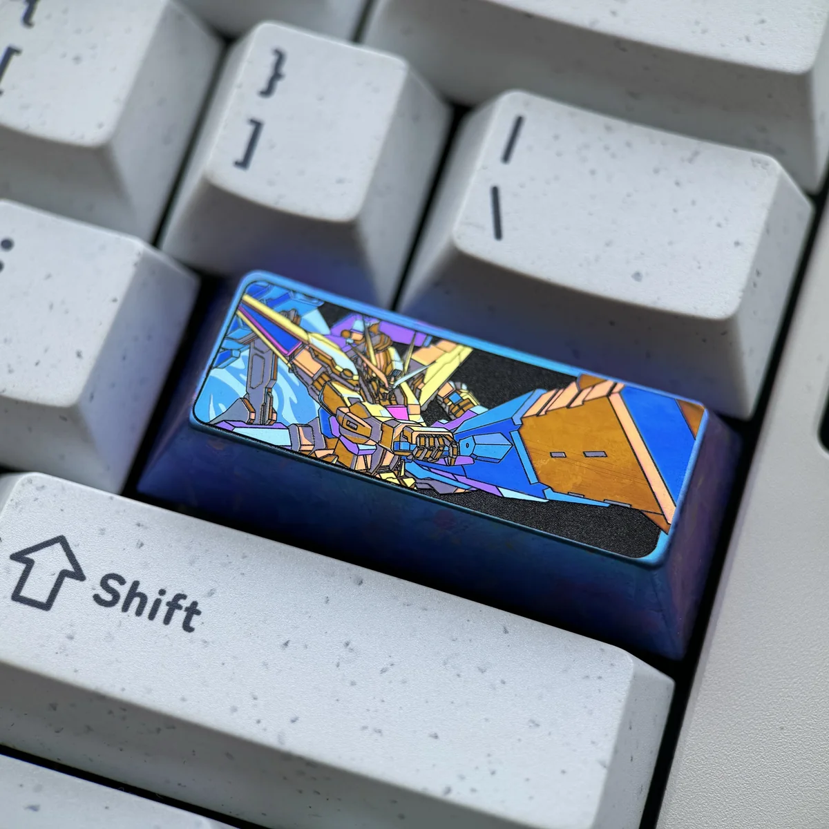 A vibrant anodized 2.25U Gundam titanium keycap, revealing its premium mecha spirit and industrial sci-fi design from multiple angles.