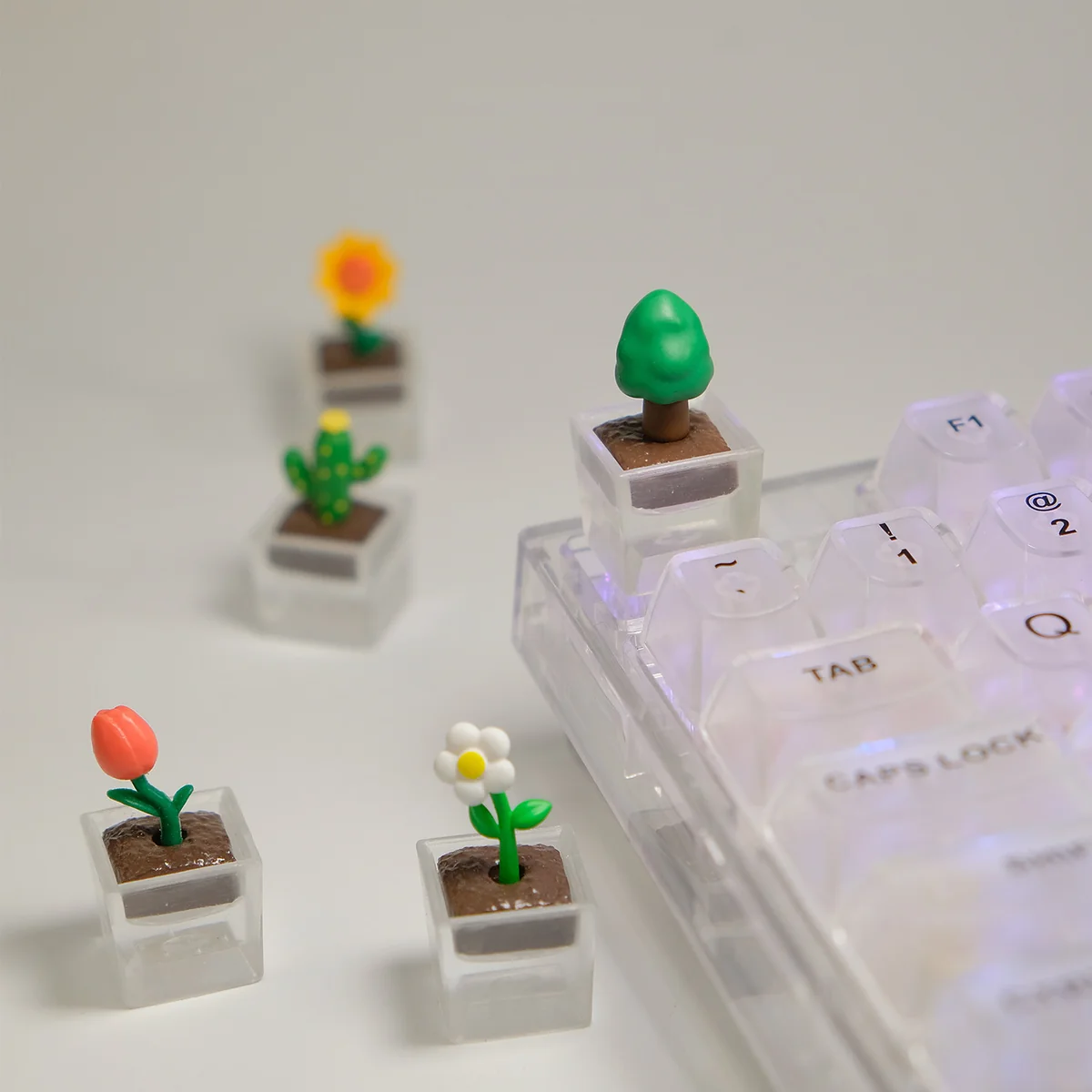 Close-up gallery views of a handcrafted botanical art resin artisan keycap, featuring real plants encased in shimmering clear resin from multiple angles.
