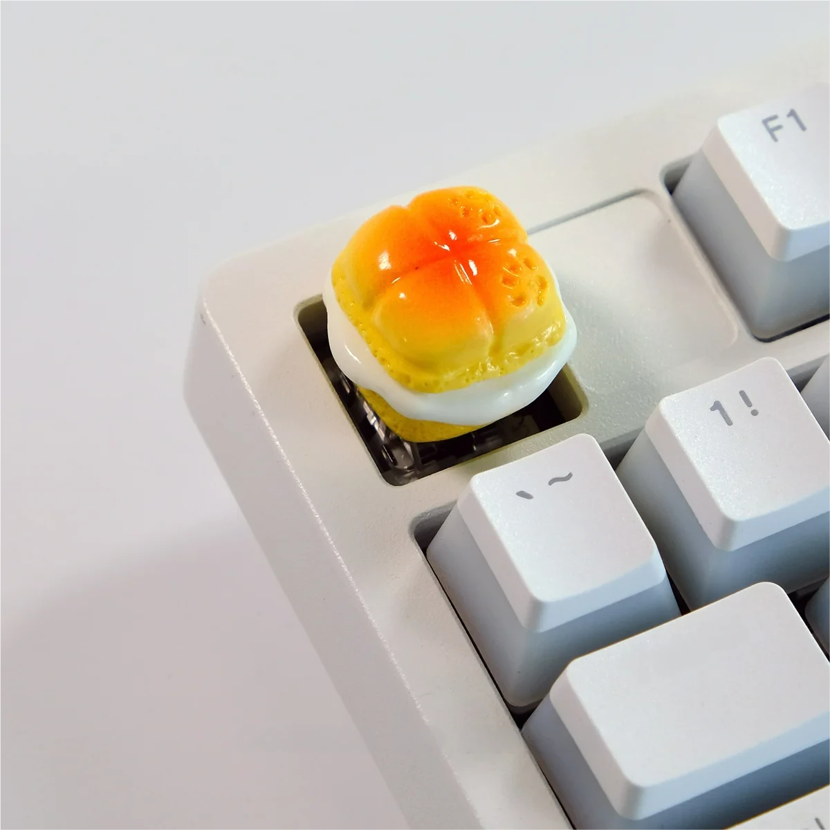 Handcrafted whimsical baked dessert artisan keycaps. Realistic miniature sweet treats displayed from various angles, highlighting them as delectable keyboard.