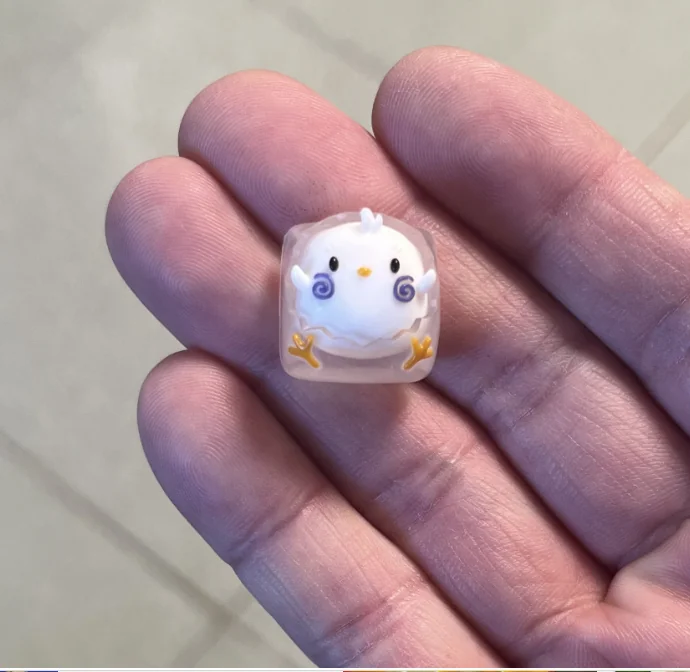 Handcrafted resin animal artisan keycap gallery, showcasing whimsical designs and vibrant, detailed resin from various angles, emphasizing unique artisan.