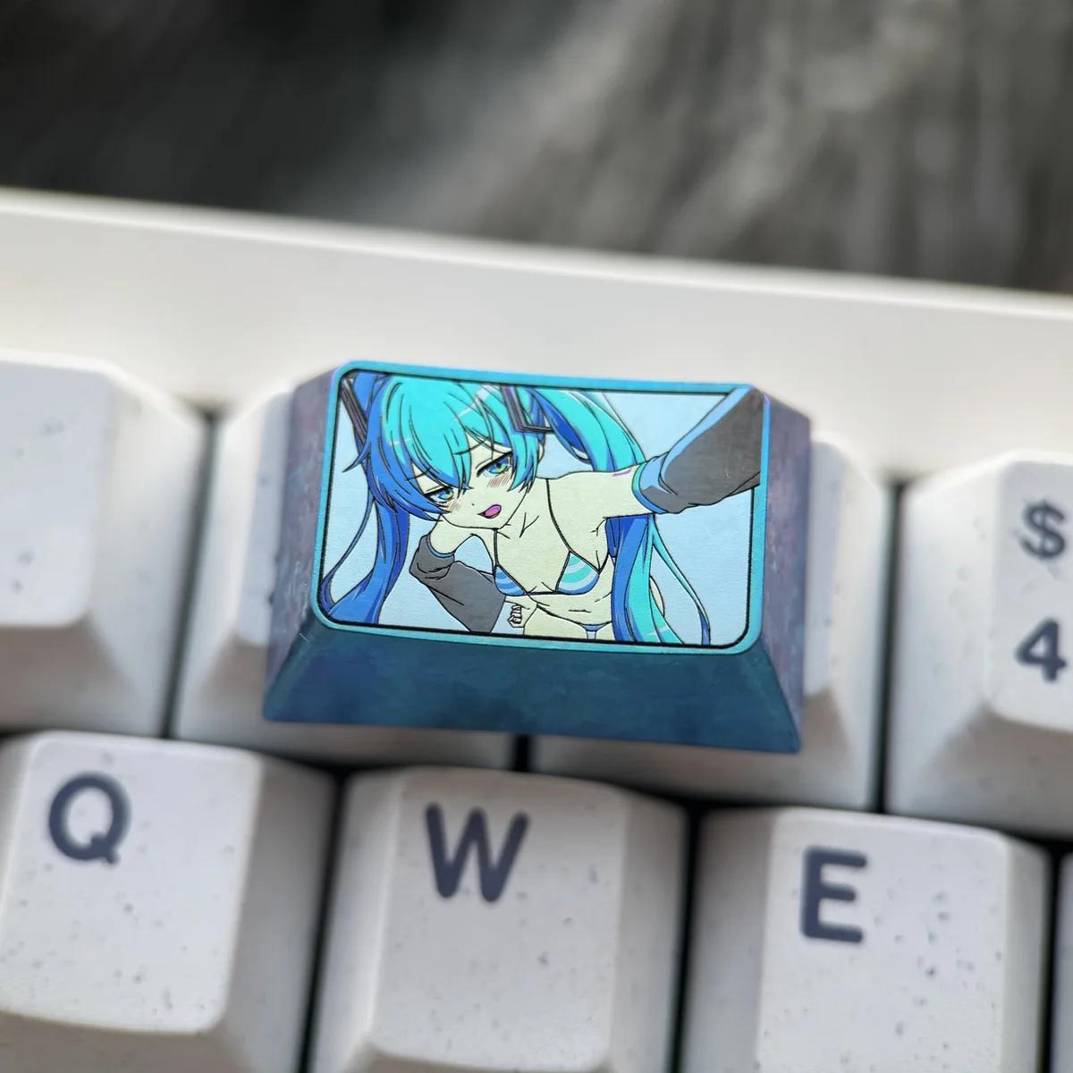 Exclusive Hatsune Miku Titanium Artisan Keycap, a vibrant anime art piece on polished titanium for your 1.5U Tab.