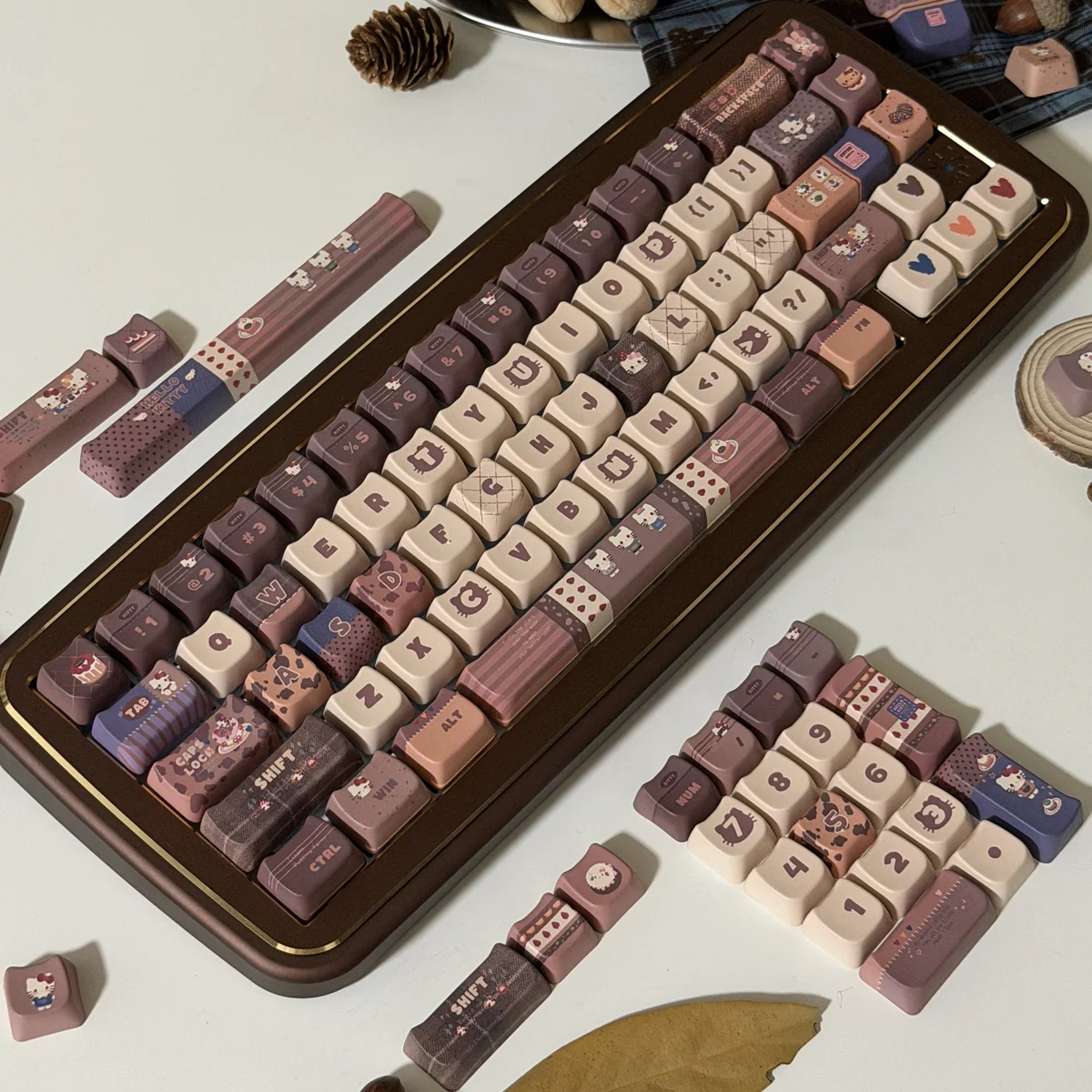 Exclusive Hello Kitty Mont Blanc dessert keycaps set showcased from different angles, featuring warm creamy browns and whites with playful Hello Kitty motifs.
