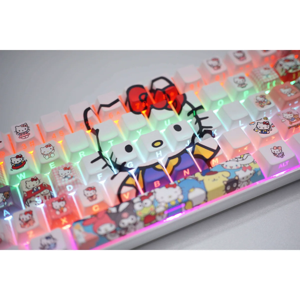 Hello Kitty side-engraved backlit keycaps set in a playful gallery view, showcasing iconic graphics, subtle side legends, and vibrant RGB glow.