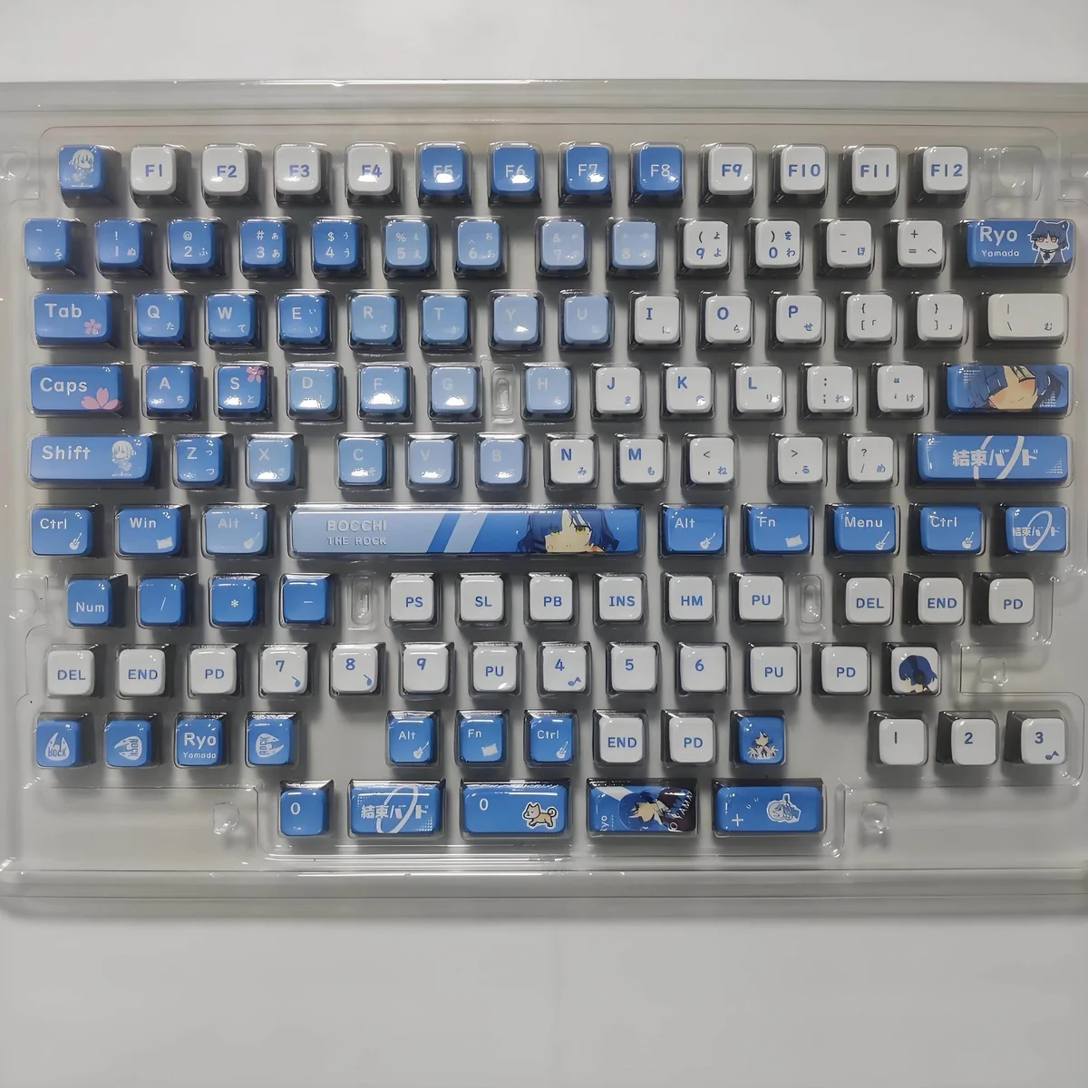 Vibrant Bocchi the Rock backlit keycaps set from an appealing angle, highlighting the glowing four-sided anime character art for keyboard enthusiasts.