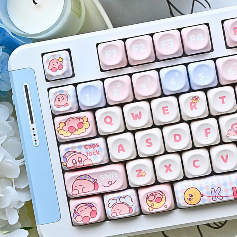 Adorable Kirby PBT MOA keycaps from the set, showcasing various angles and the whimsical pastel pink design with charming Kirby characters.