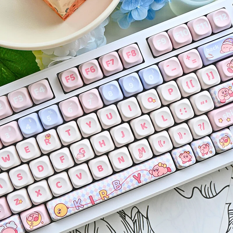 Adorable Kirby PBT MOA mechanical keycaps set in whimsical pastel pink, showcasing charming Kirby characters. This playful set is viewed from different angles.