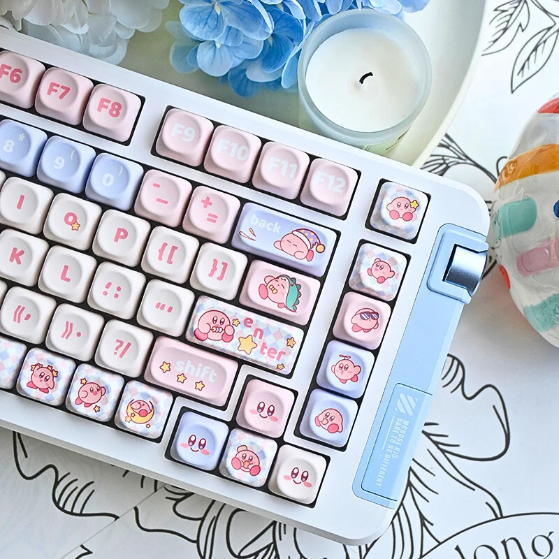 Adorable Kirby PBT MOA mechanical keycaps set displayed from various angles, showcasing the whimsical pastel pink design and charming Kirby characters.