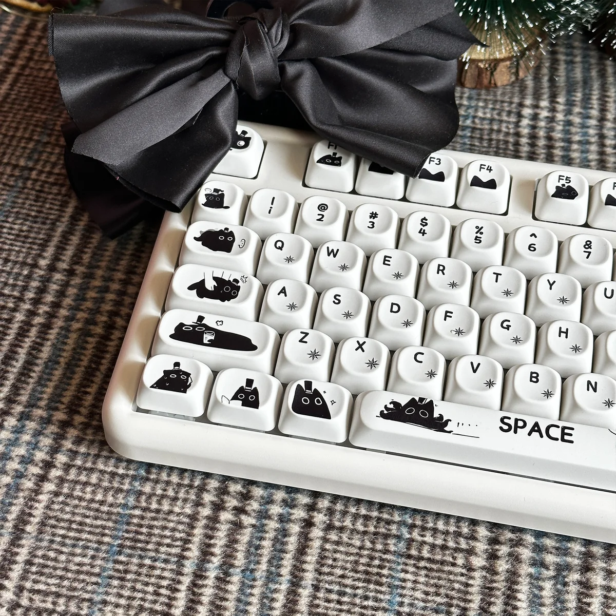 An artistic product gallery showcasing multiple angles of the Klein Moretti PBT cat keycaps set, highlighting their iconic minimalist feline designs.