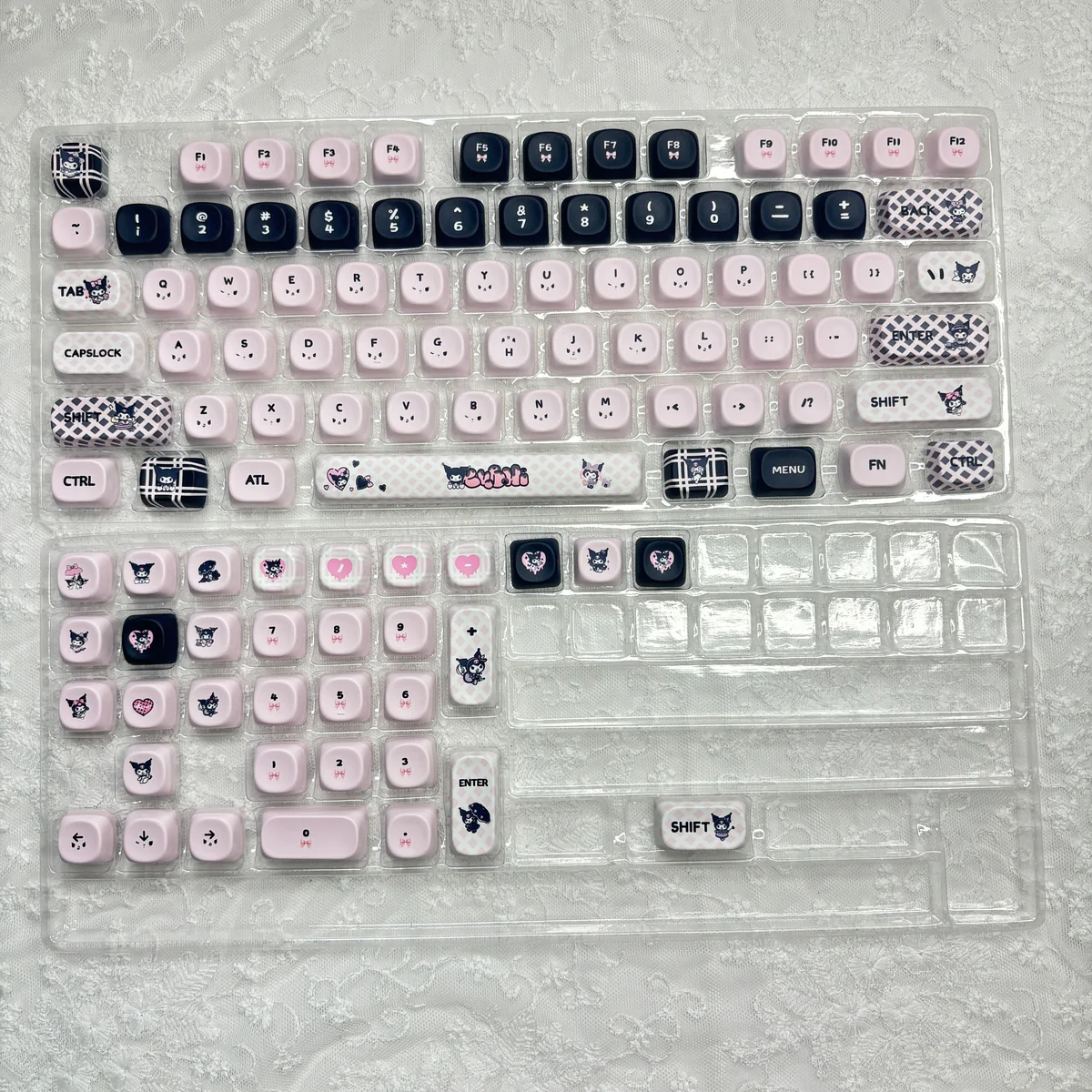 Mischievous Kuromi PBT dye-sub keycaps set at various angles, showcasing iconic black, pink, and white gothic-kawaii designs. Durable and playful for keyboard.