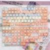 Close-up of charming Maillard Bear PBT dye-sub keycaps set in warm caramel and brown, highlighting the cute bear designs and premium texture from various angles.