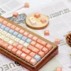 Close-up of the charming Maillard Bear PBT dye-sub keycap set, showcasing cute bear illustrations in warm caramel and brown tones from various angles.