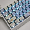 A collection of cute Maltese Dog RGB keycaps set viewed from multiple angles, highlighting their unique four-sided translucent design and playful vibrant light.