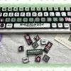 A gallery of Subaru Awa MDA keycaps set from various angles, showcasing their sleek ergonomic MDA profile and vibrant four-sided translucent RGB lighting.