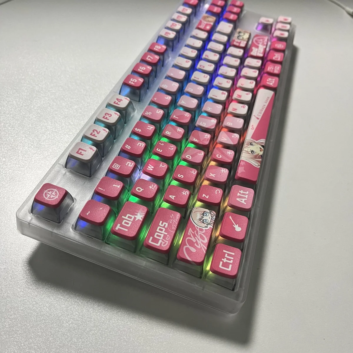 Dynamic MyGO Chihaya Anon glowing PBT keycaps set from multiple views, highlighting their all-sided translucent glow and playful anime art.