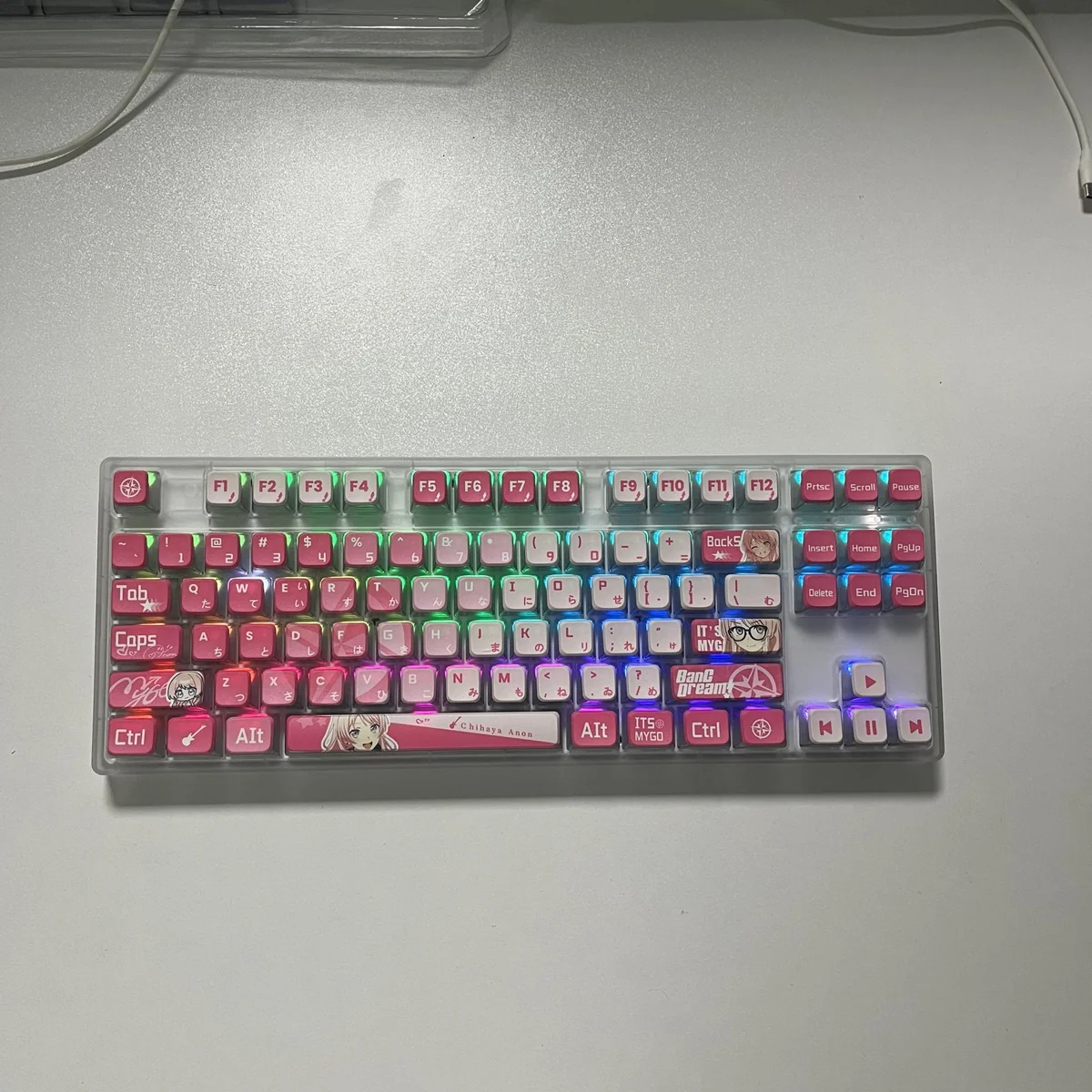 Dynamic gallery views of exclusive MyGO Chihaya Anon translucent PBT keycaps set, highlighting their vibrant glowing anime character art from all sides.