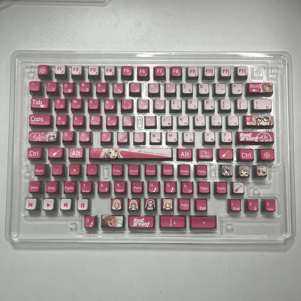 MyGO Chihaya Anon glowing PBT keycaps set displayed from multiple angles, showcasing their exclusive all-sided translucent design and vibrant anime character design.