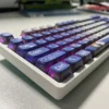 Artistic gallery views of the MyGO Tomori translucent PBT keycaps set, showcasing vibrant four-sided anime luminescence and melancholic artistry.