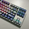 MyGO Tomori translucent PBT keycaps set. Artistically shown from diverse angles, highlighting its four-sided glow and vibrant anime luminescence.