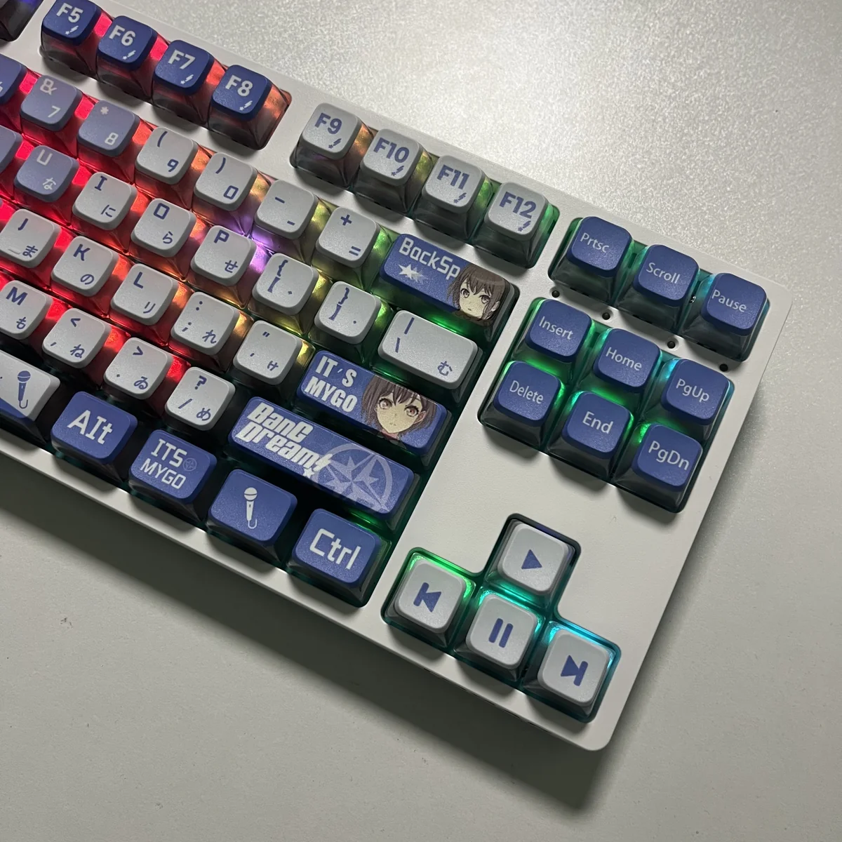 MyGO Tomori translucent PBT keycaps set. Artistically shown from diverse angles, highlighting its four-sided glow and vibrant anime luminescence.