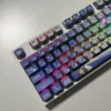 MyGO Tomori translucent PBT keycaps set, captured from various angles, revealing their four-sided anime-inspired luminescence with a radiant RGB glow.