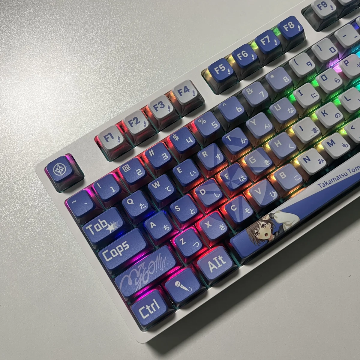 MyGO Tomori translucent PBT keycaps set, captured from various angles, revealing their four-sided anime-inspired luminescence with a radiant RGB glow.
