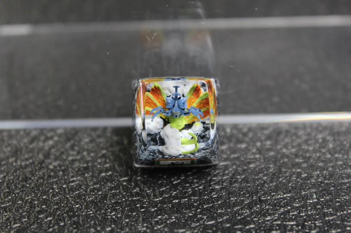 Close-up views of the handcrafted Chomei's Spirit Naruto artisan resin keycap, revealing its vibrant Tailed Beast sculpture and intricate details.