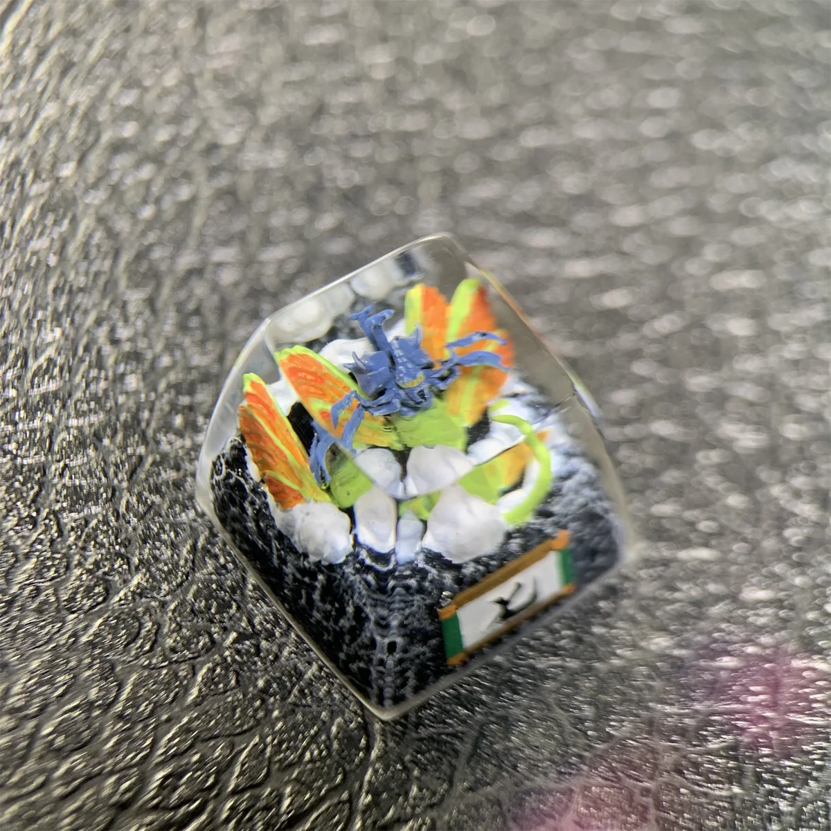 Handcrafted Naruto artisan resin keycap. Vibrant, intricate Seven-Tails sculpture from a detailed angle. Artistic Naruto keycap.
