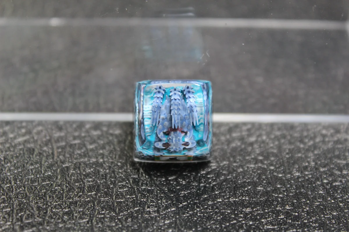Close-up views of the handcrafted Naruto Isobu Tailed Beast resin keycap, highlighting its ethereal aquatic design and vibrant sky-blue artistry design.