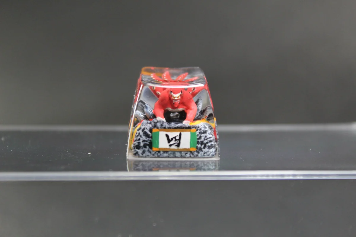 Handcrafted Naruto Four-Tails resin keycap showcasing vibrant red details of the powerful beast from multiple artistic angles.