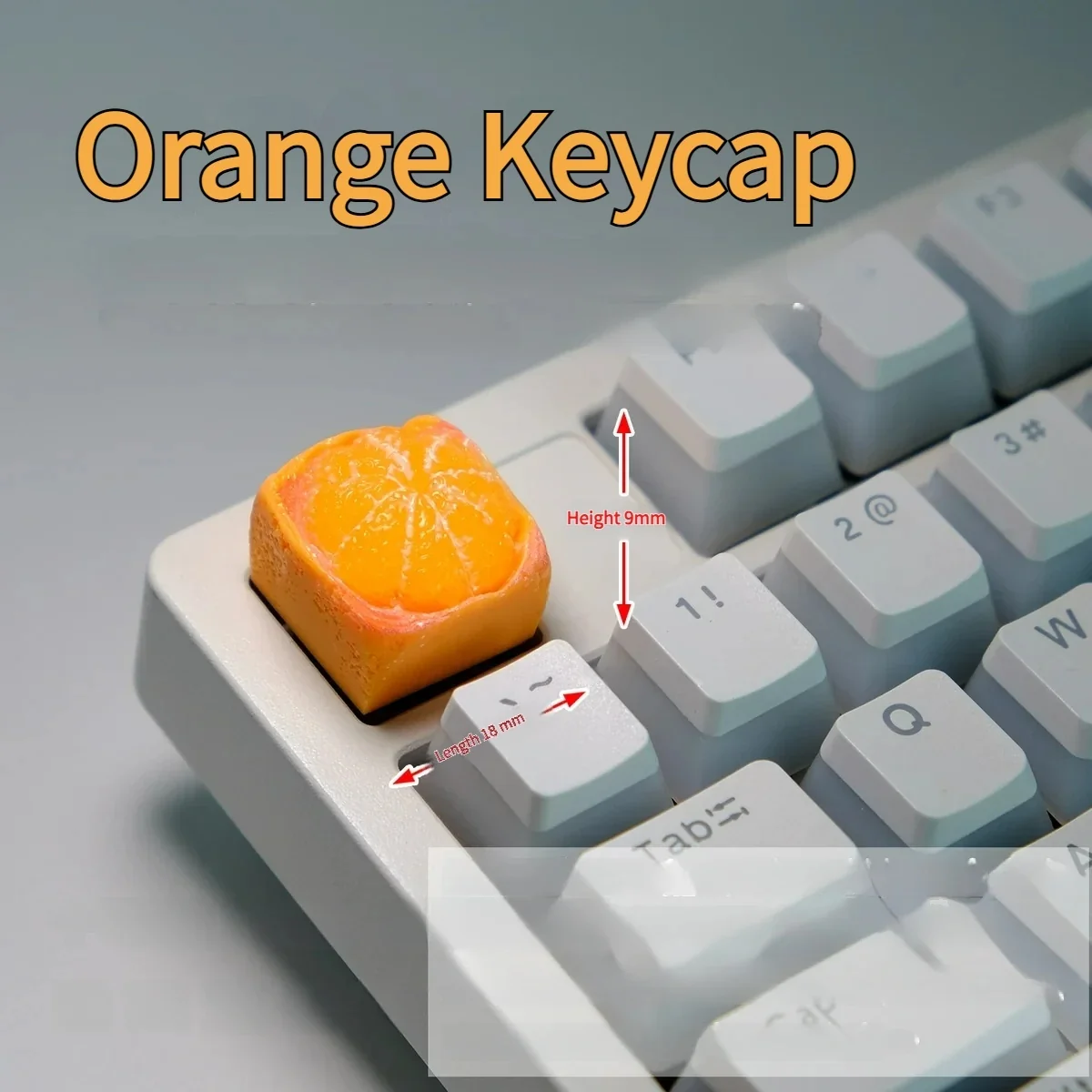 Playful handcrafted orange artisan keycap shown from a captivating angle, highlighting its whimsical miniature fruit design and vibrant details for mechanical keyboard.