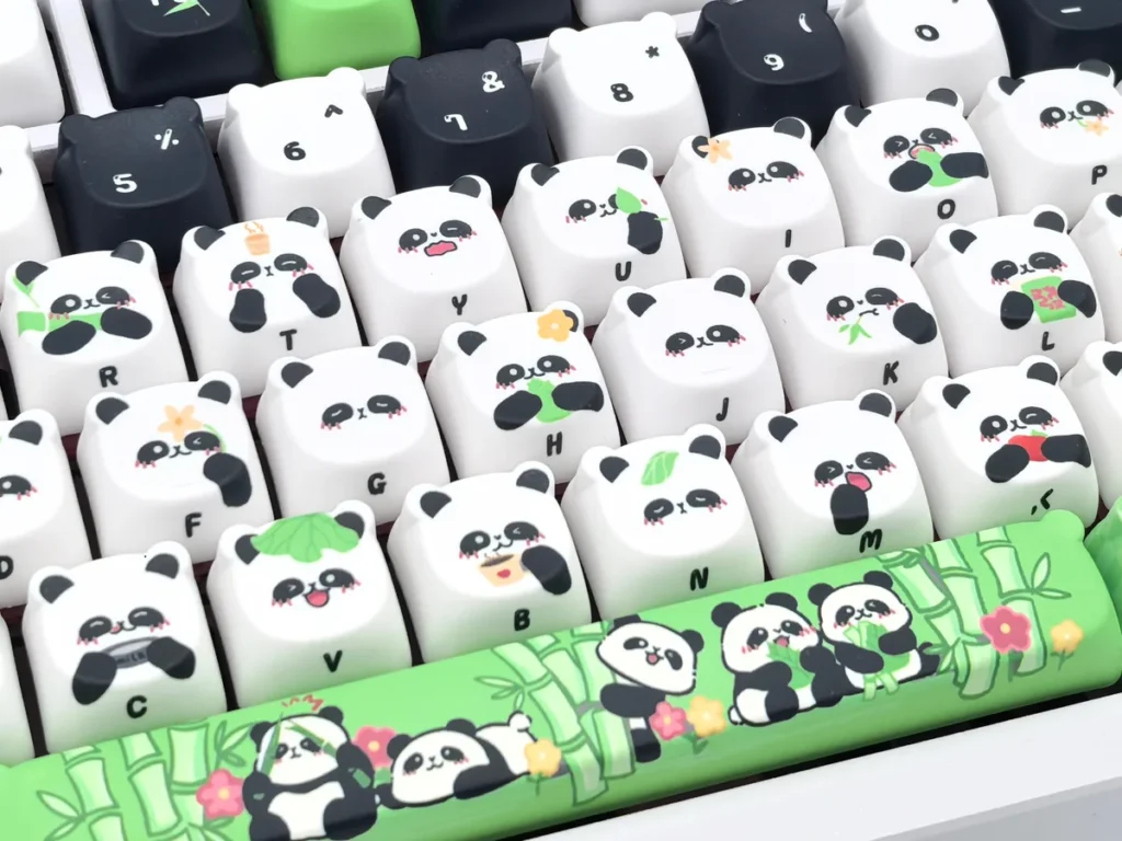 Detailed views of the exquisite handcrafted panda artisan keycap set, showcasing its whimsical miniature sculpture and meticulous black and white design.