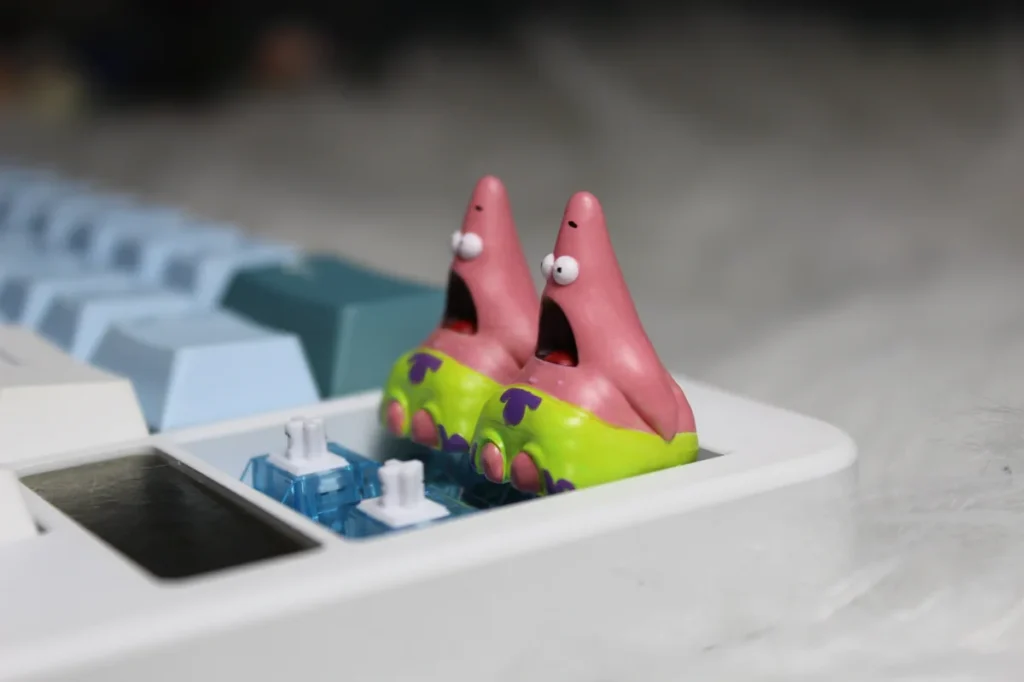 Multiple views of a whimsical handmade pink Patrick Star resin artisan keycap, highlighting its detailed craftsmanship as a beloved cartoon character.