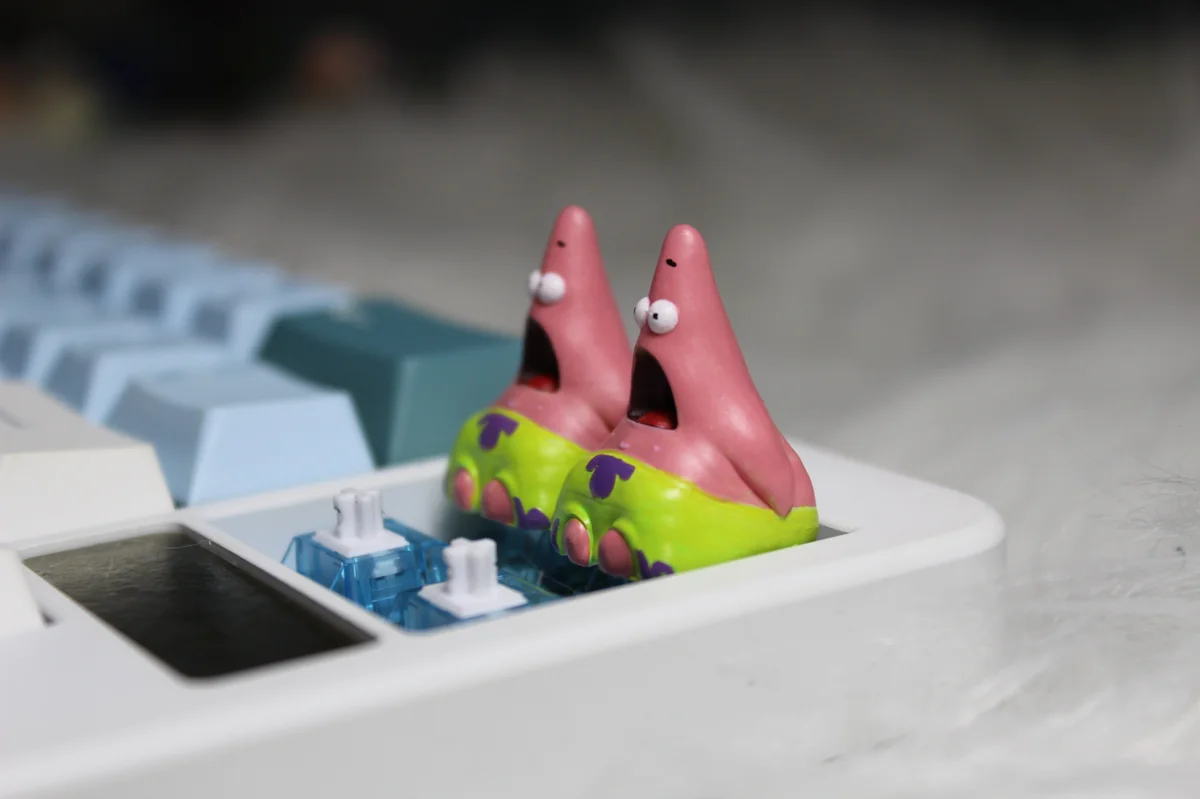 Multiple views of a whimsical handmade pink Patrick Star resin artisan keycap, highlighting its detailed craftsmanship as a beloved cartoon character.