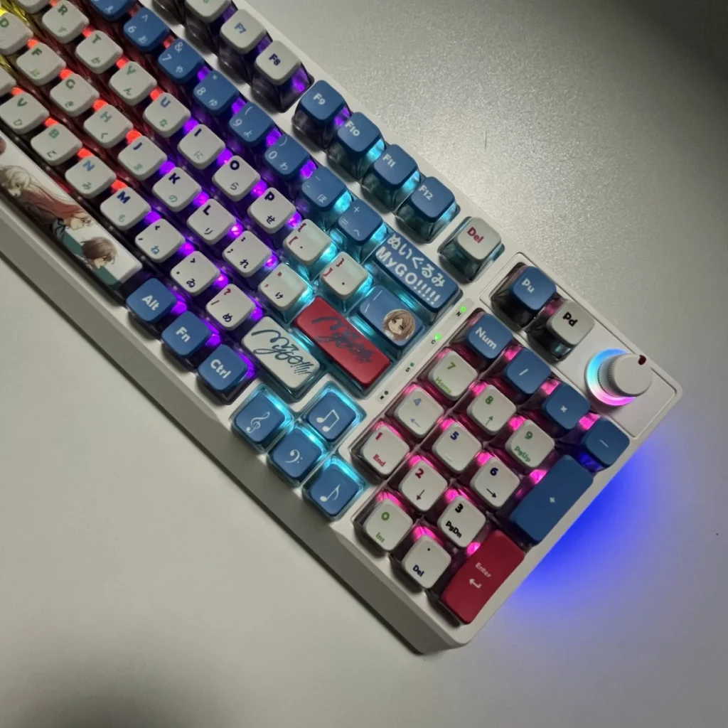 Playful gallery shot of vibrant RGB PBT MyGO Band Theme keycap set featuring a comfortable MDA profile, showcasing their immersive translucent glow from all angles.