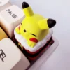 Multiple angles of a vibrant, festive handcrafted 3D resin Pikachu keycap, showcasing its intricate sculpting and playful charm for mechanical keyboard.