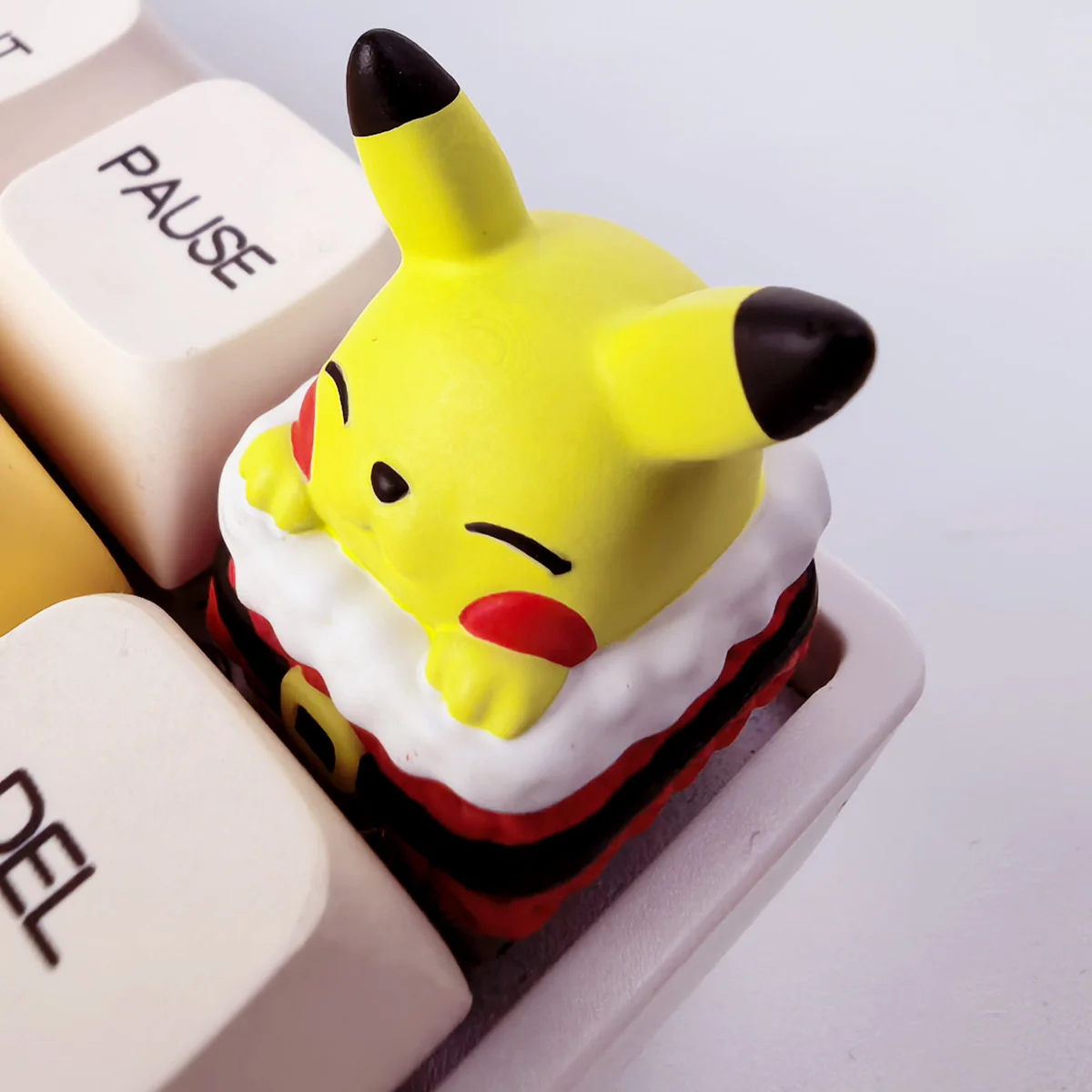 Multiple angles of a vibrant, festive handcrafted 3D resin Pikachu keycap, showcasing its intricate sculpting and playful charm for mechanical keyboard.