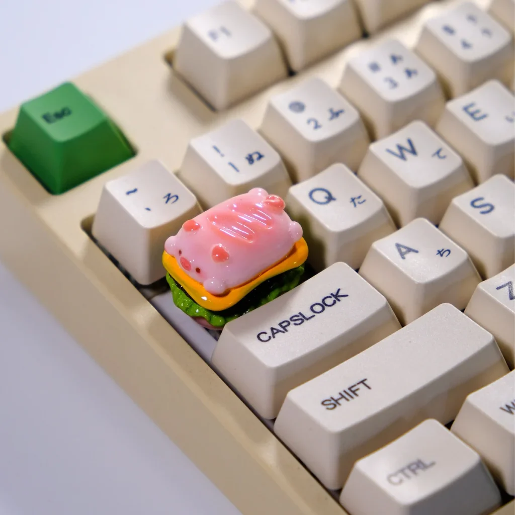 A whimsical pink Pig Pie handcrafted 3D artisan keycap, featuring a glossy food-inspired design for unique mechanical keyboards.