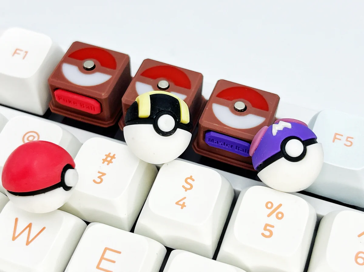 Showcasing vibrant 3D okemon Poke Ball, Great Ball, and Master Ball keycaps from various angles, highlighting their iconic sculpted form.